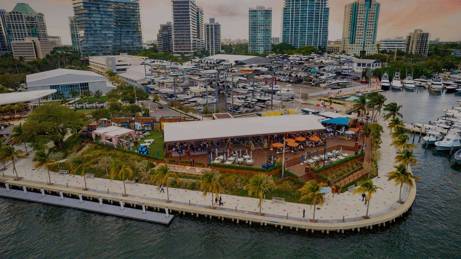 Guests enjoying food, drink, and the water view at a Breakwater Hospitality property.
