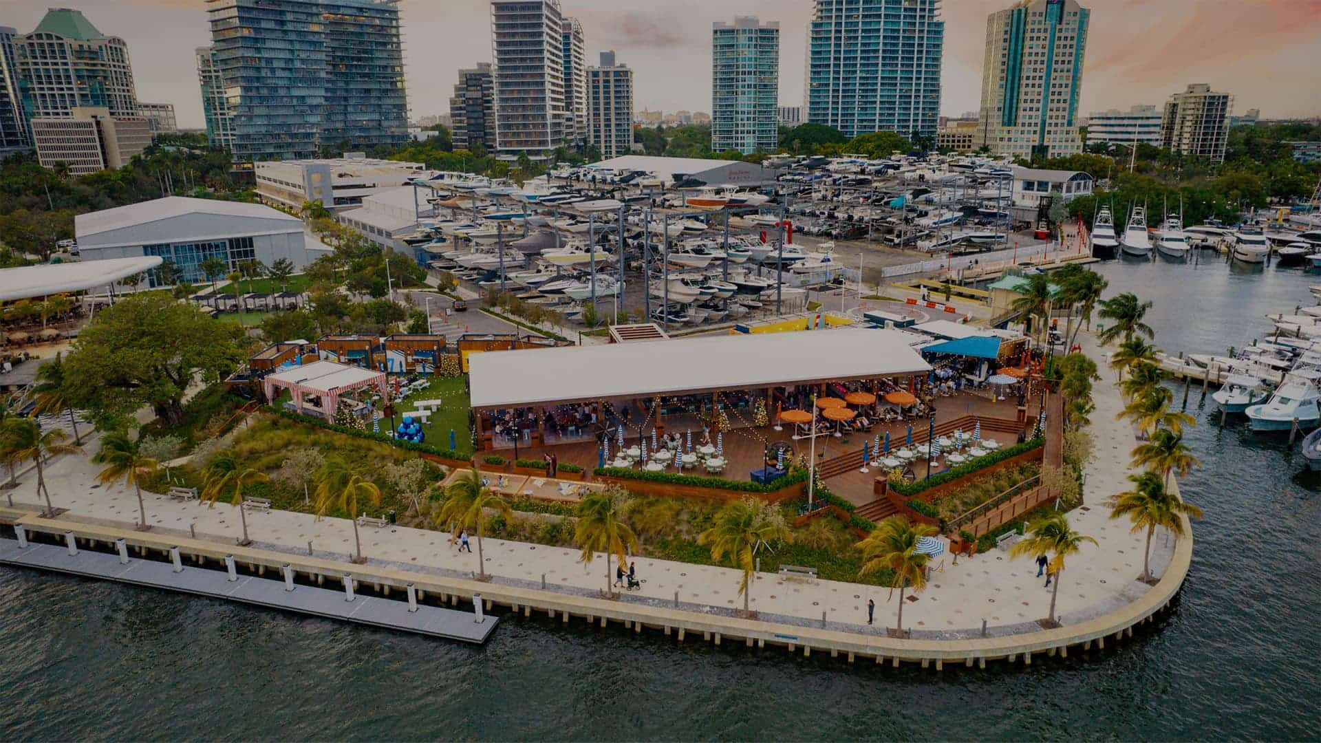 Guests enjoying food, drink, and the water view at a Breakwater Hospitality property.