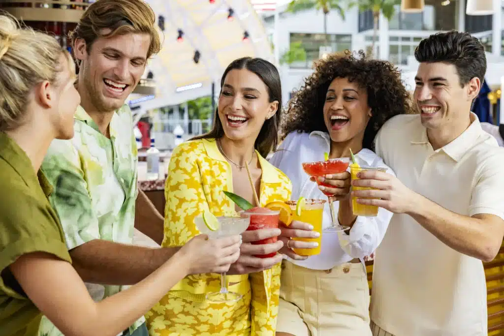 People doing a cheers with cocktails at Pier 5